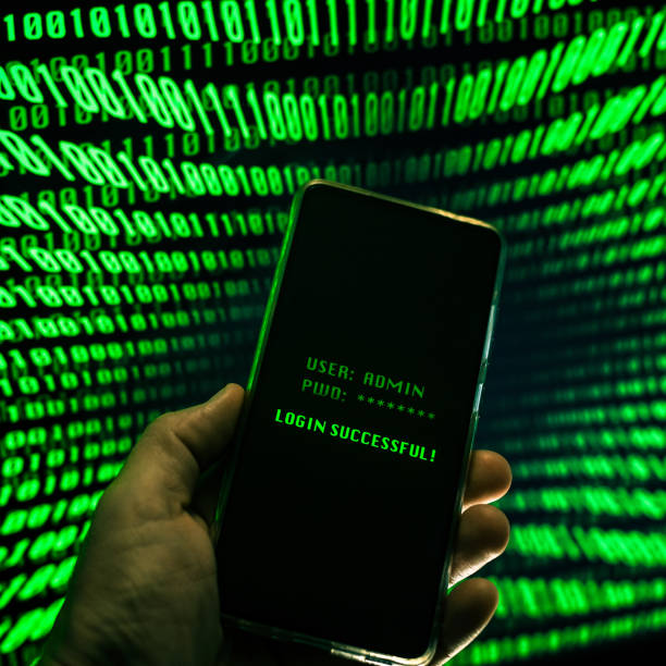 istock Hand with smartphone doing successful login in a digital network. Display with green numbers in background. Hacker forced the system. Technology, communication, security, protection, intrusion concept 1354233067