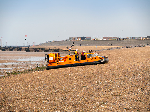 H-003, the ‘Hunstanton Flyer’, an RNLI (Royal National Lifeboat Institution) rescue hovercraft during a training exercise on the South Beach at Heacham in Norfolk, Eastern England. The ‘Hunstanton Flyer’, based in the town of the same name just along the coast, is one of only a few of these H-Class rescue craft, which are used in areas where sands are vast and incoming tides can have fatal consequences when unwary beach-lovers find themselves cut off on a sandbank. Being manoeuvrable in places with shallow water and on sandbanks, the ‘Flyer’ is perfect for this area of The Wash and parts of the North coast of Norfolk.