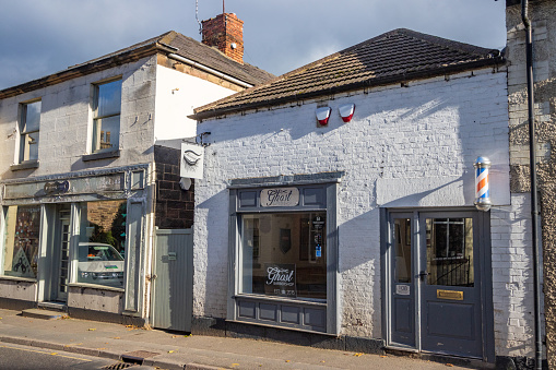 Ghost Barbershop of Belper in Derbyshire, England, with other shops visible in the background