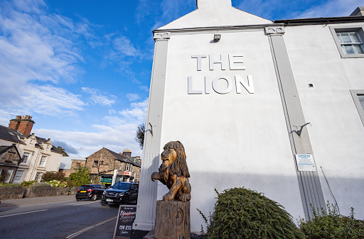 The Lion Belper in Derbyshire, England, with a sculpture of a lion and car number plate visible