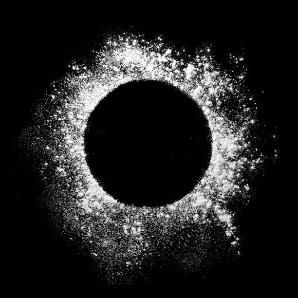 istock Flour is scattered from a bowl on a black table. top view. 1354236670