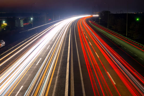 istock Night Car Traffic With Trails on a Suburban Highway 1354237404