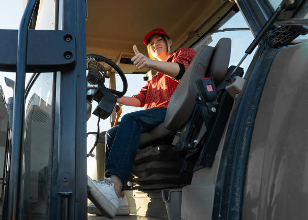 istock Girl farmer drives a tractor. Agricultural machine 1354237714