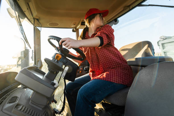 istock Girl farmer drives a tractor. Agricultural machine 1354237721