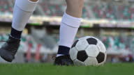 istock Close up of female soccer player at the stadium kick the ball during football match 1354239261