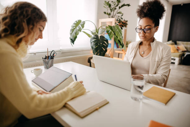 istock Young business women working in modern office 1354239279