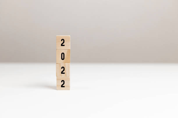 istock Wooden blocks with message 2022 Number on white table on light background. New Year's composition 1354239332