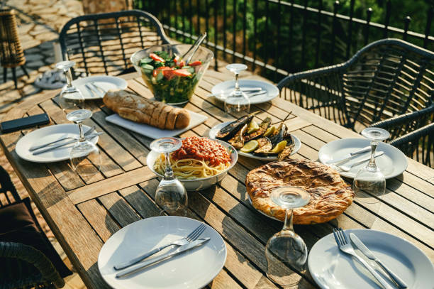 istock Shot of a table set with food and dinnerware outside 1354240222