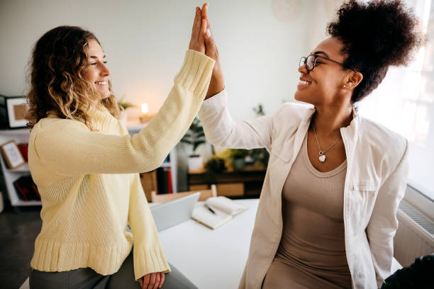 istock Two business women work in office. They work happily 1354240485