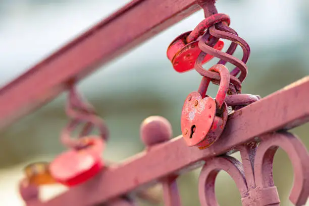 Photo of Love padlocks on bridge in city. Symbol of eternal bond.