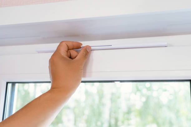 istock Supply ventilation on a plastic window, a man's hand moves the ventilation lever on the window 1354240799