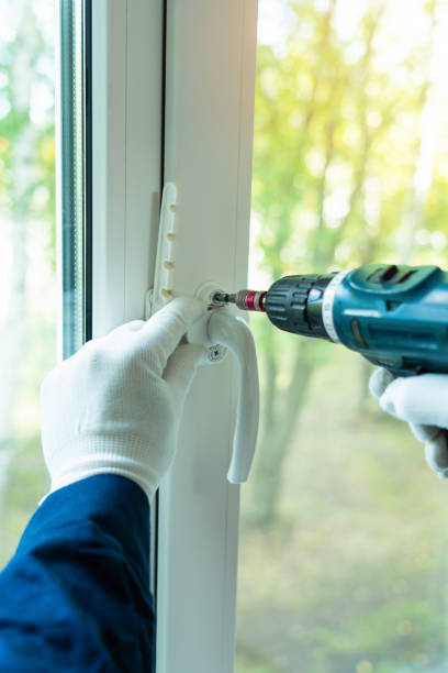istock A man installs a white plastic handle on the window with an electric screwdriver close-up 1354240811