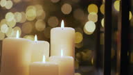 istock Beautiful Christmas candles with Christmas lights in the background 1354242914