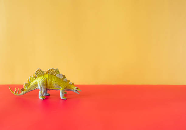 istock Fun Toy Dinosaur On A Brightly Colored Background 1354243885