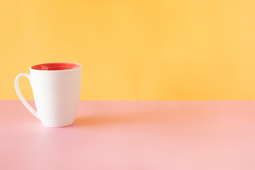 White mug on a colorful background with lots of copy space.