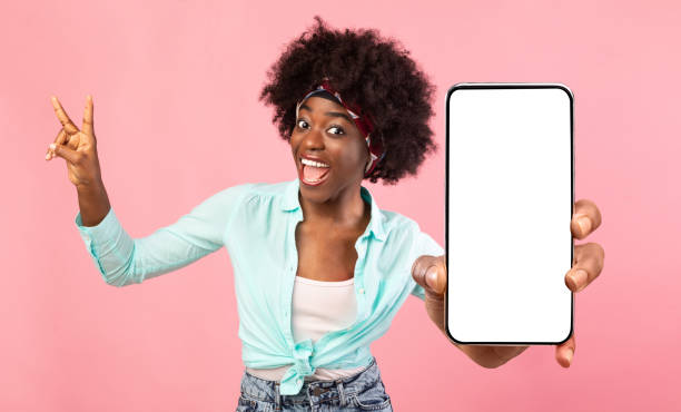 istock Emotional black woman demonstrating smartphone with empty screen 1354244018
