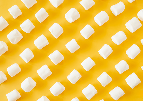 bright yellow base with marshmallows arranged in diagonal rows.