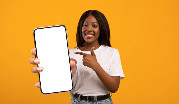 istock Cheerful attractive black lady with cellphone, mockup 1354244407