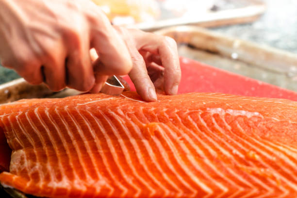 istock Chef cutting Salmon Fillet 1354246925