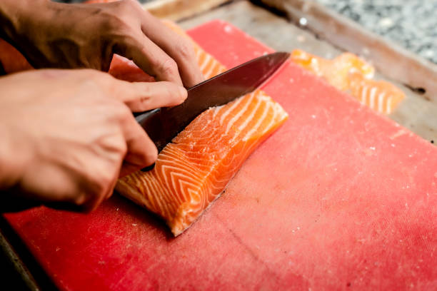 istock Chef cutting Salmon Fillet 1354246994
