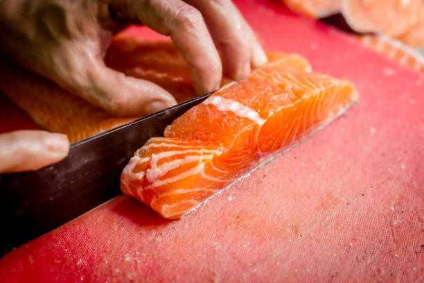 istock Chef cutting Salmon Fillet 1354247005