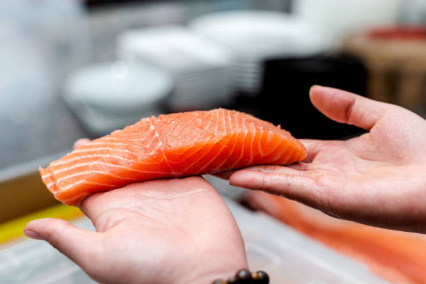 Chef cutting Salmon Fillet