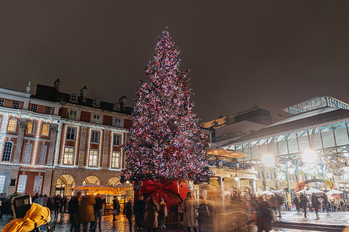 Christmas tree and moving people around in London UK,