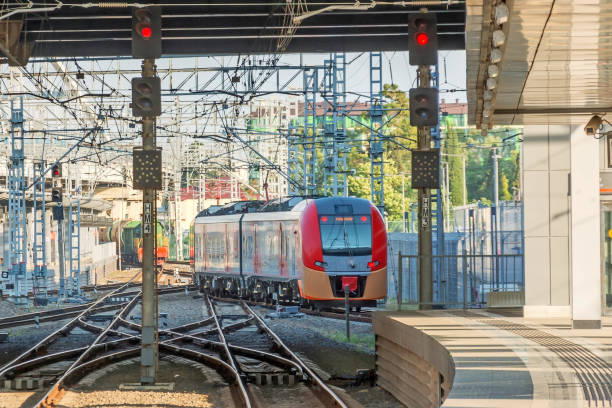 istock Train passing a railroad crossing. Dutch signs warning not go and red lights flashing. 1354248233