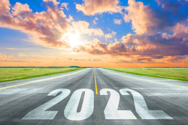 istock New Year 2022 Goals Concept. Empty asphalt road sunset with text 2022. 1354248285