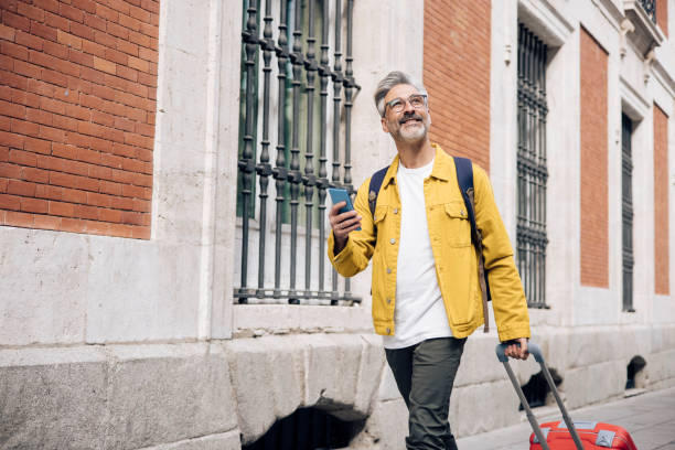 istock Mature man arriving to Madrid and using GPS for sightseeing 1354249475