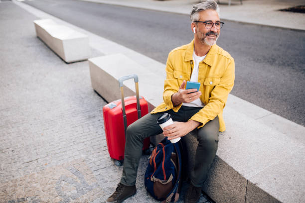 istock Mature tourist taking a coffee break and texting 1354249518