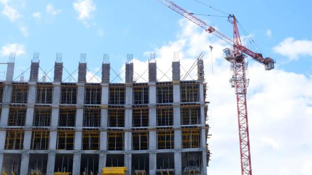 istock Construction site with scaffolding, a residential building under construction and a crane on the background of the sky. Housing construction, apartment building in the city, mortgage 1354249657