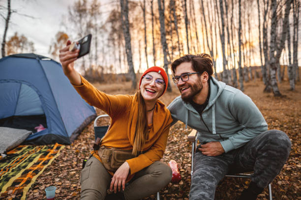 istock Young couple taking selfie on camping 1354250929