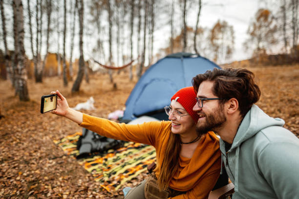 istock Young couple taking selfie on camping 1354251017
