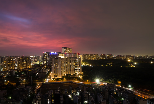 Beautiful view of city lights,light trails,colorful sky at night during monsoons in Delhi NCR’s posh locality namely - DLF 5 Residential apartments and commercial business hub on July 20,2021.