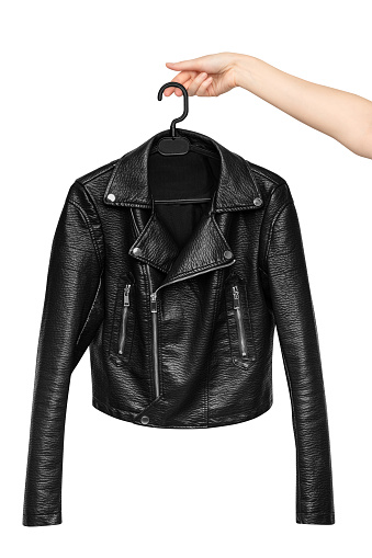 Woman leather jacket design concept on hanger holding in hand front view isolated on white background.