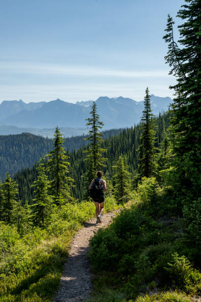 istock Woman Happily Hikes Down Trail in Glacier 1354252914