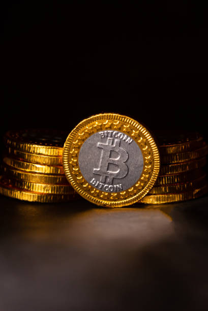 istock Close up of gold bitcoin on black background with selective focus 1354253271