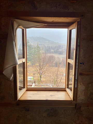 Construction workers installing windows on wooden house