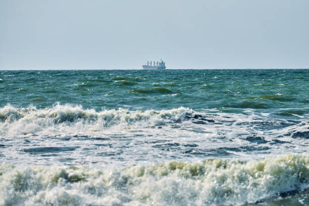 istock Unloaded container cargo ship freighter, import export trade logistic, cargo ship in blue sea 1354254361