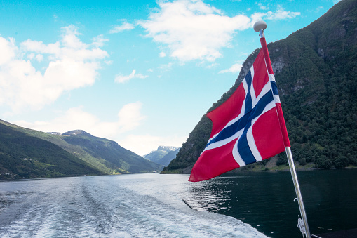 Norway flag wave close up. Full page Norway flying flag. Highly detailed realistic 3D rendering.