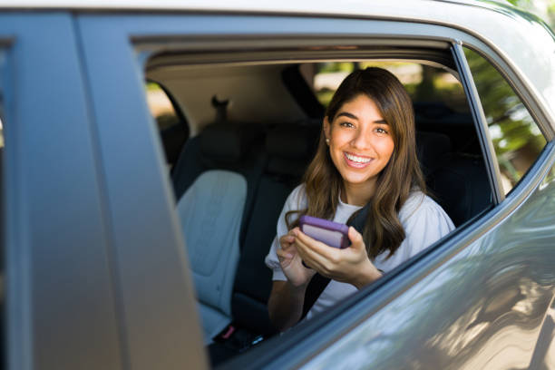 istock Beautiful woman on a carpool car 1354257400