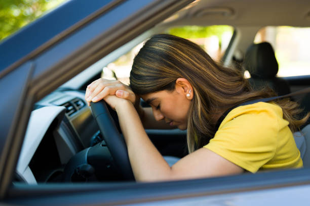 istock Sad woman on a long drive commuting 1354257640