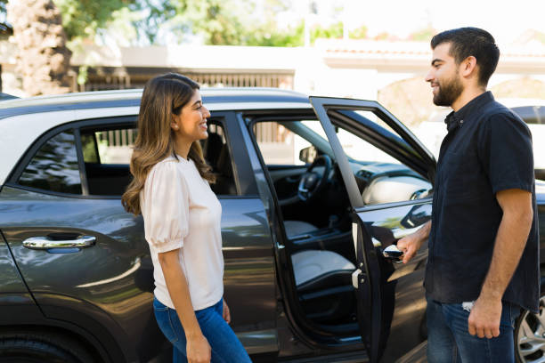 chivalrous man on a date with a woman - vehicle door imagens e fotografias de stock