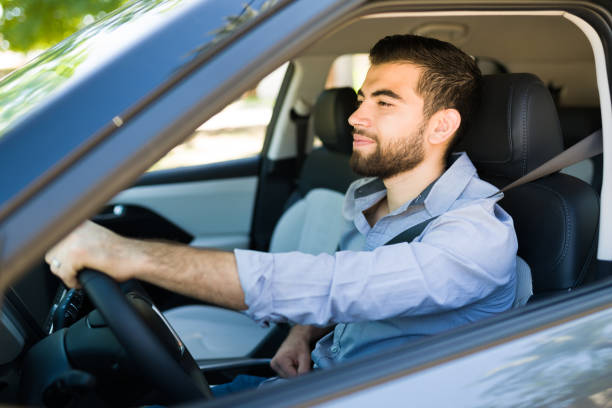 istock Attractive man driving his new car 1354258037