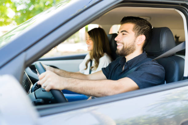 istock Young woman and man driving away 1354259312