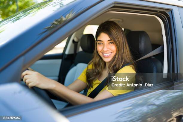 Portrait Of A Latin Woman In The Drivers Seat Stock Photo - Download Image Now - Crowdsourced Taxi, Driving, Car Pooling