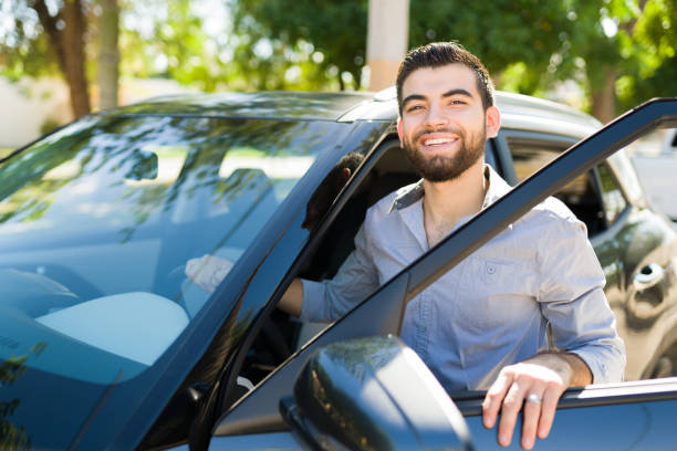 istock Smiling man getting in the car 1354259476
