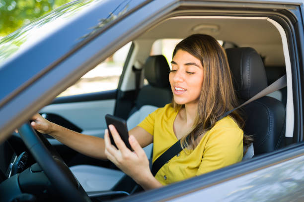 istock Young woman calling her boyfriend while driving 1354259486