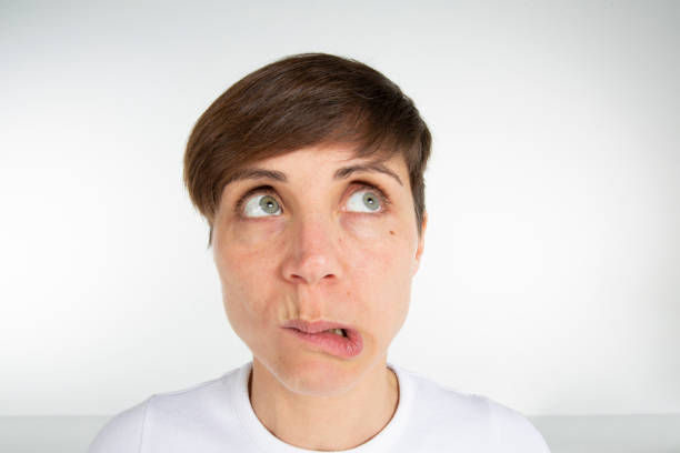 Close up of a beautiful woman in her thirties doing a gesture with her face